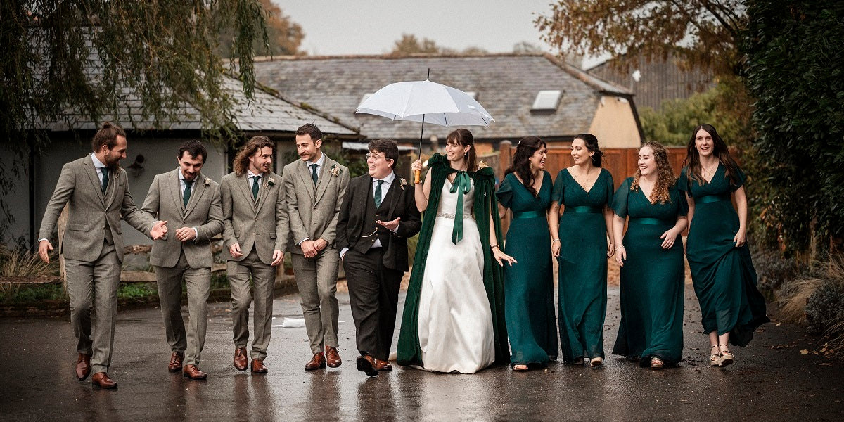 groomsmen suits with dark green bridesmaid dresses